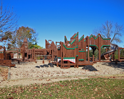 wood playground with green accents