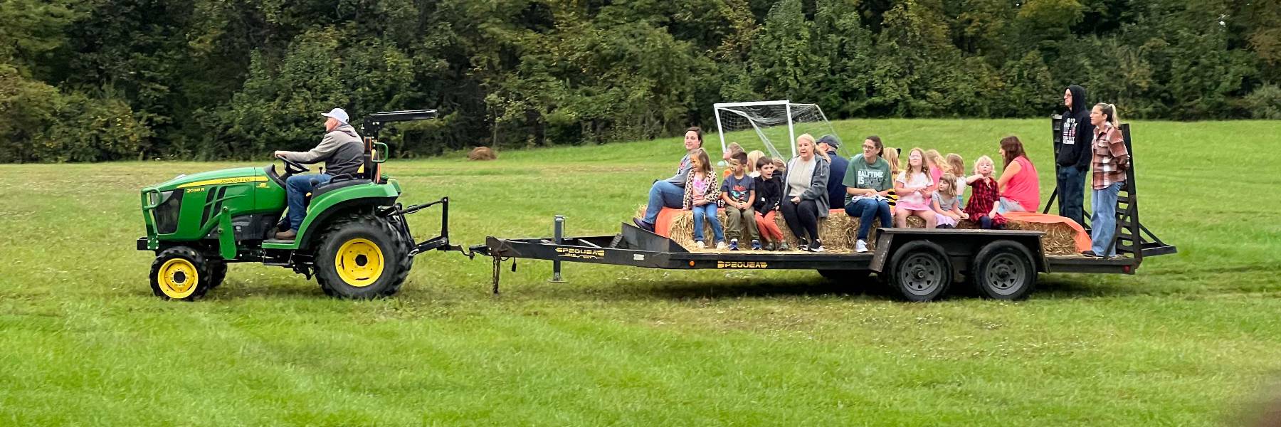 Families on a tractor hayride at Fall Harvest