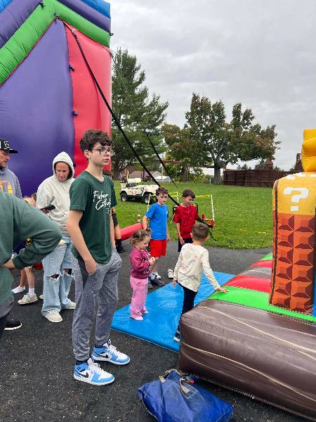 Kids lined up at the bounce house