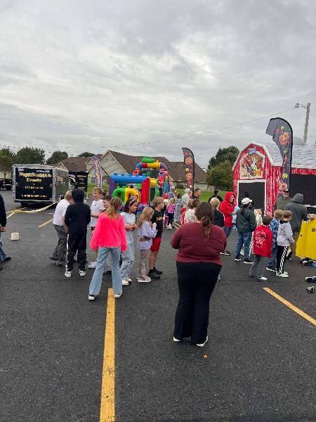 Kids gathered by the bounce houses