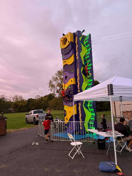 Climbing wall lit up at dusk
