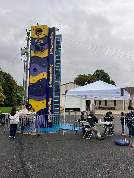 Girl near the top of the climbing wall