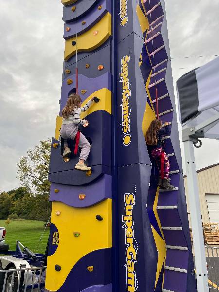 Two girls climbing side by side