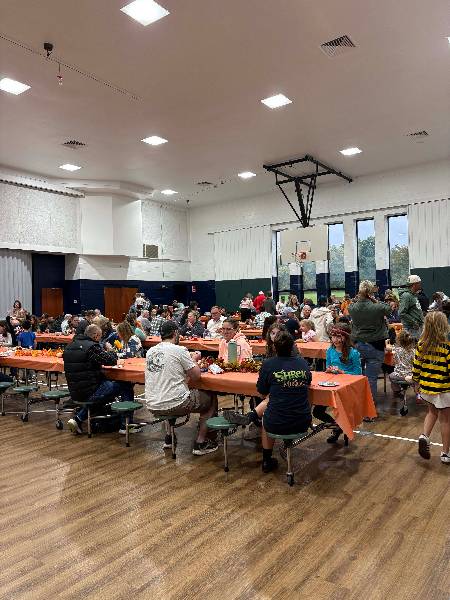 Families eating dinner in the gym