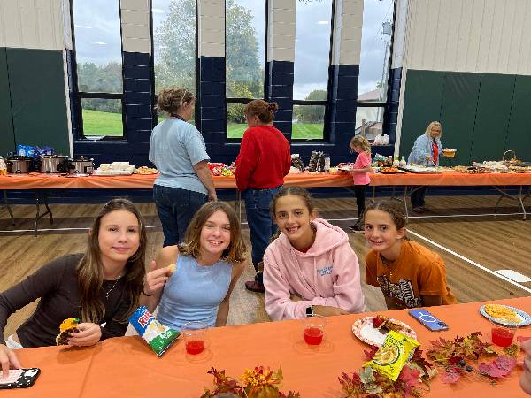 Four girls at dinner by the food table