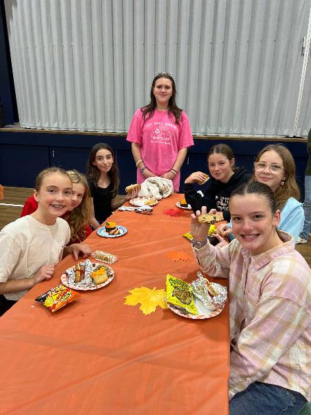 Students sharing dinner at a long table