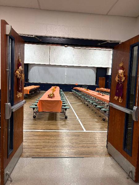 Decorated tables seen through the gym doors