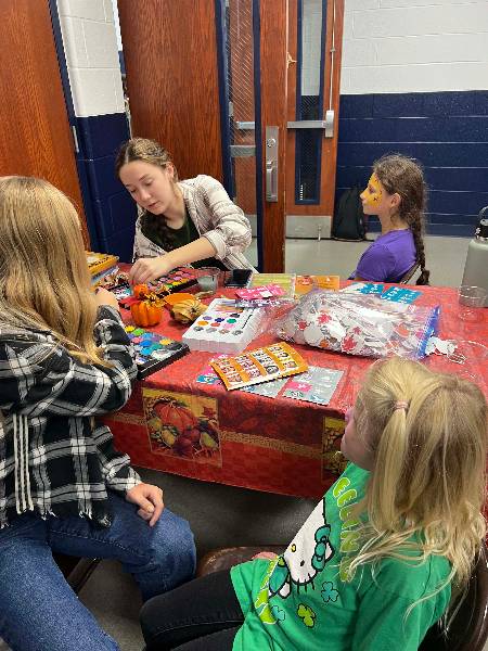 Face painting table with volunteers