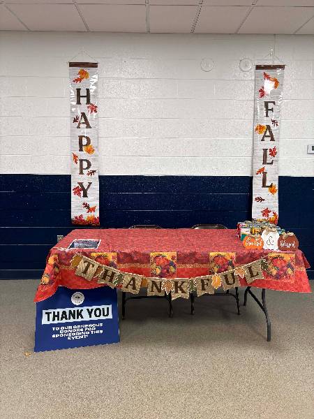 Happy Fall food drive table with sponsor thank-you sign