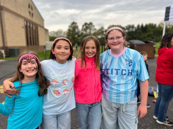 Four friends showing their face paint