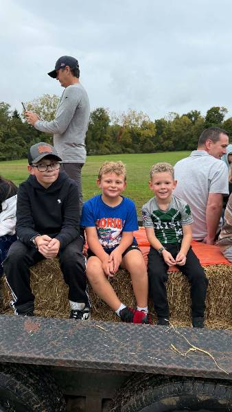 Three boys on the hay wagon