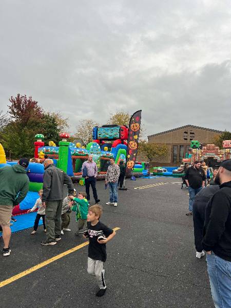 Families among the inflatables in the parking lot