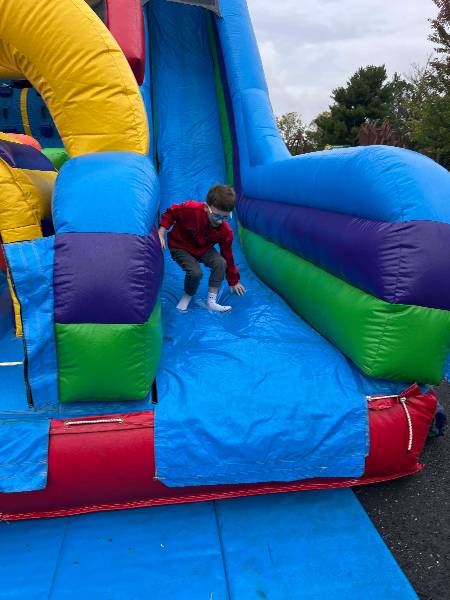 Boy coming down the inflatable slide