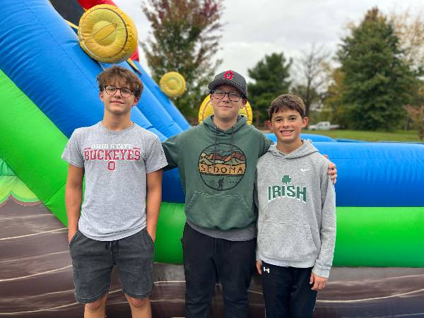 Three friends by the video-game slide