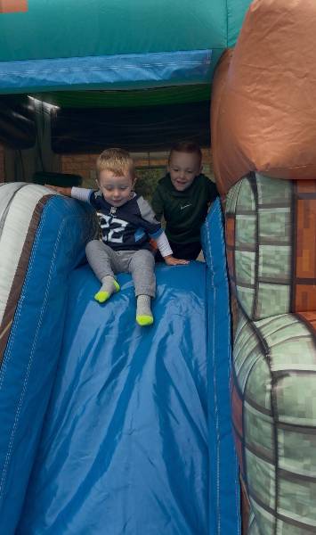 Two little boys at the top of a slide