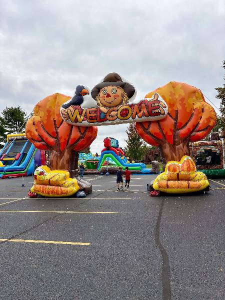Fall Harvest welcome arch with a scarecrow