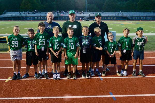 Flag football team smiling with coaches