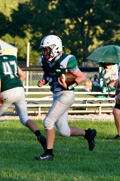 Irish ball carrier follows a block from number 47