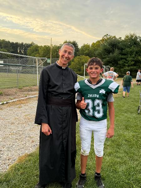 Father smiles with player number 33 after a game