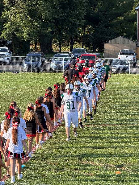 Irish players high-five the cheerleaders after the game