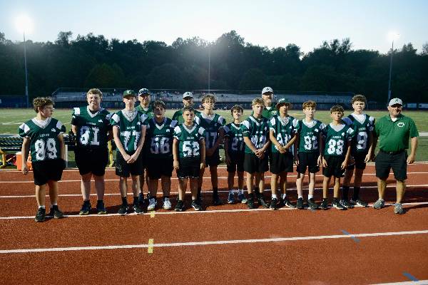 Irish middle school football team with coaches on the track