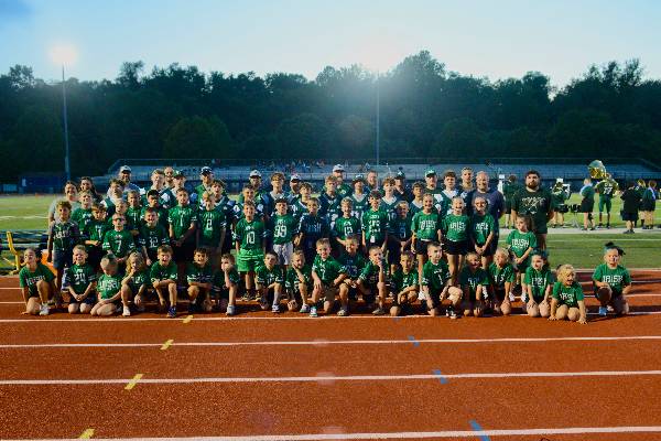 Irish flag football, cheer, and football teams together on the track