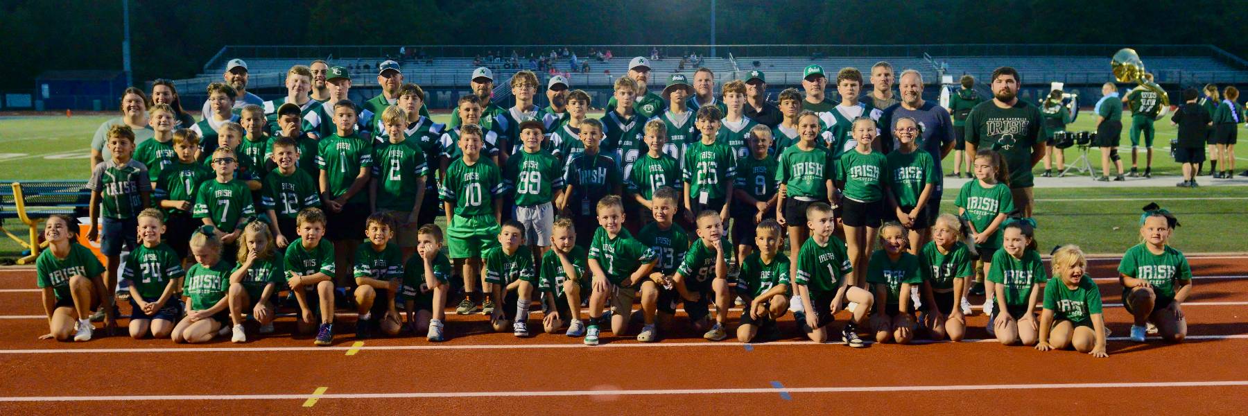 Irish flag football, cheer, and football teams together on the track