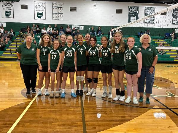 Irish volleyball team with coaches on the court