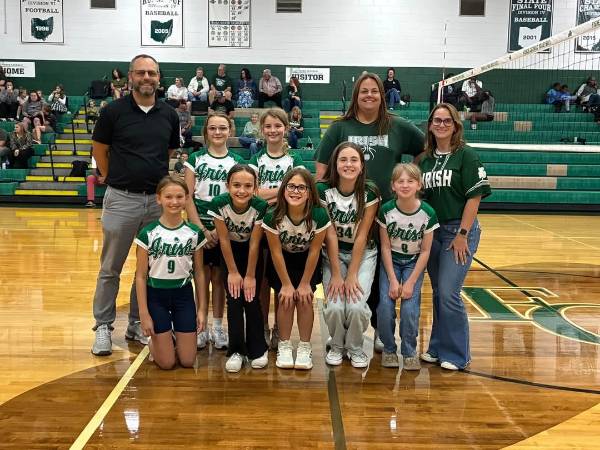 Youth volleyball team with coaches